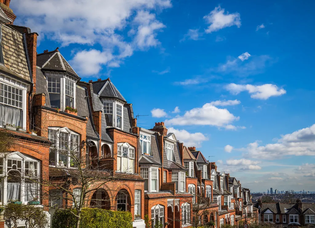 London, England - Traditional brick houses and flats on a nice summer morning with blue sky and clouds taken from Muswell Hill